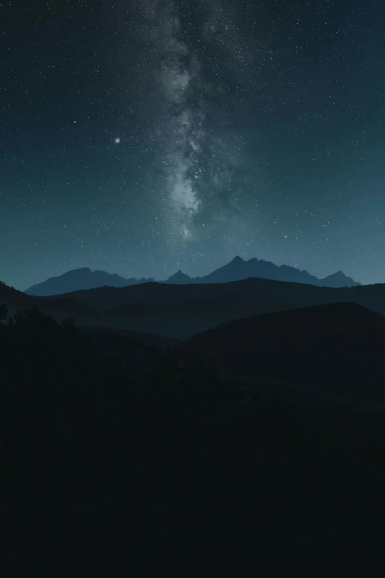 Milky way galaxy over silhouetted mountains at night
